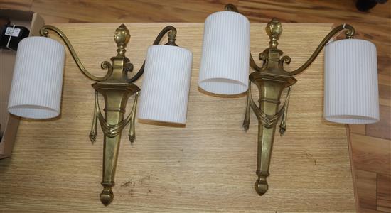 A pair of brass twin branch wall lights